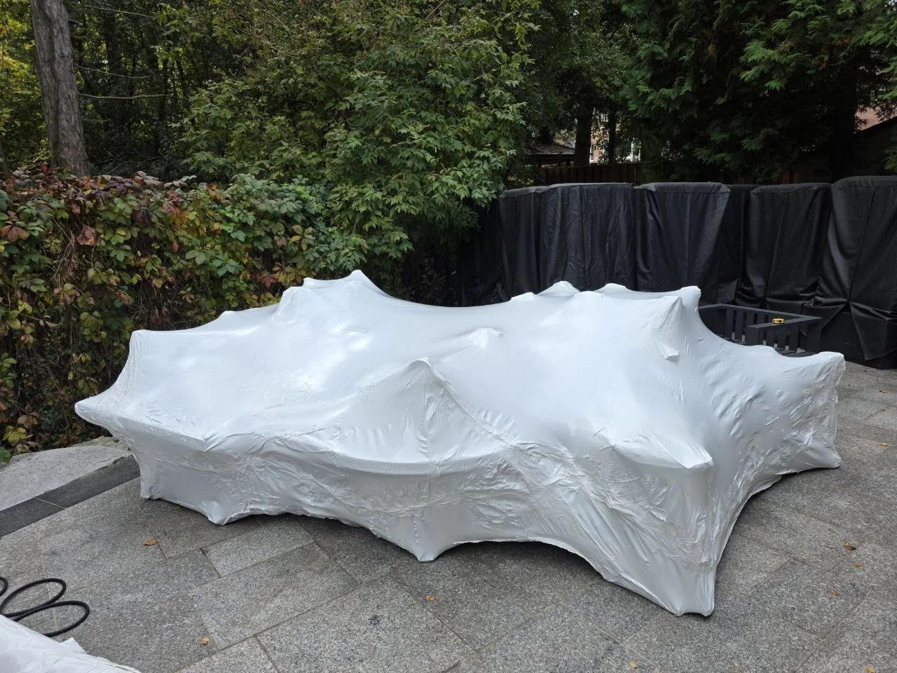 The same patio furniture grouped under fitted shrink wrap