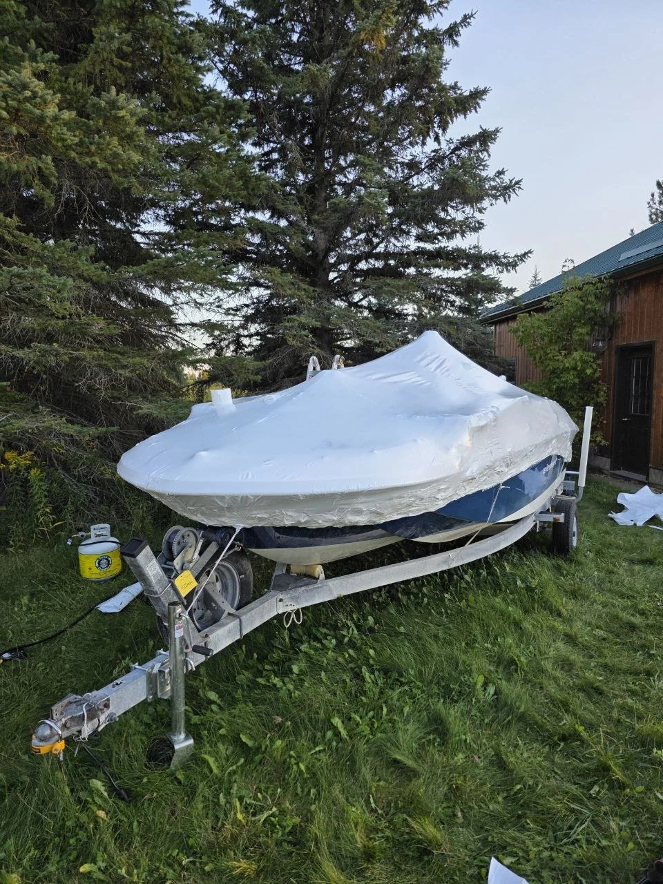 Boat protected with white shrink wrap