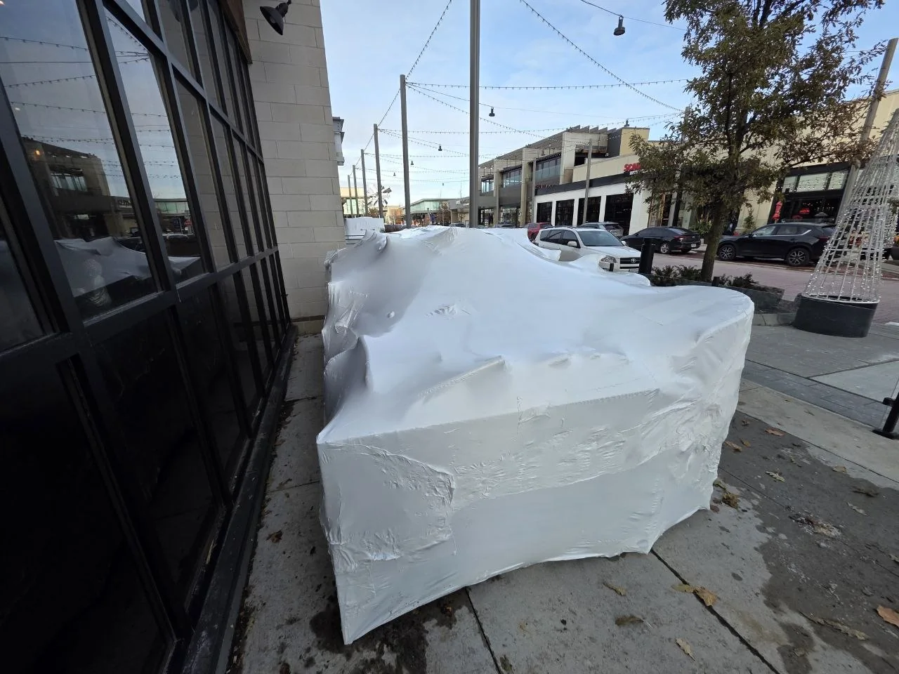 Patio furniture protected with fitted white shrink wrap