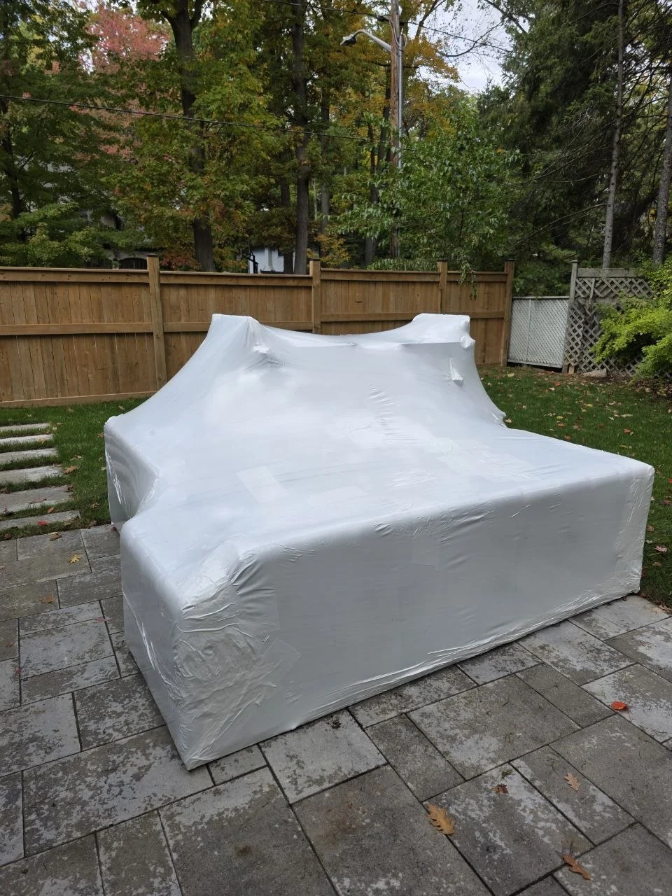Large patio set protected with fitted shrink wrap