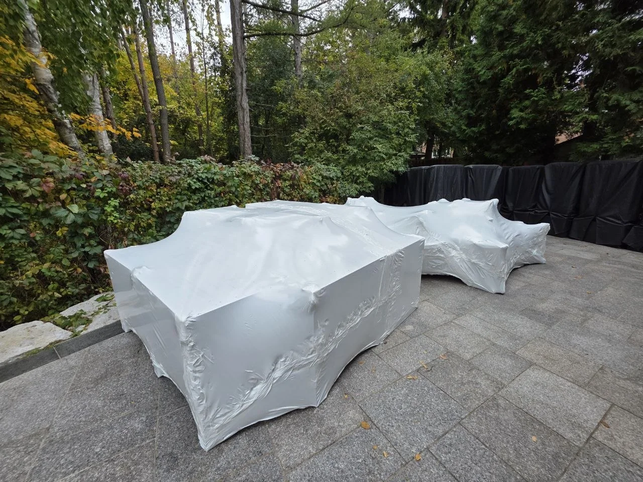 Outdoor items covered with fitted white shrink wrap