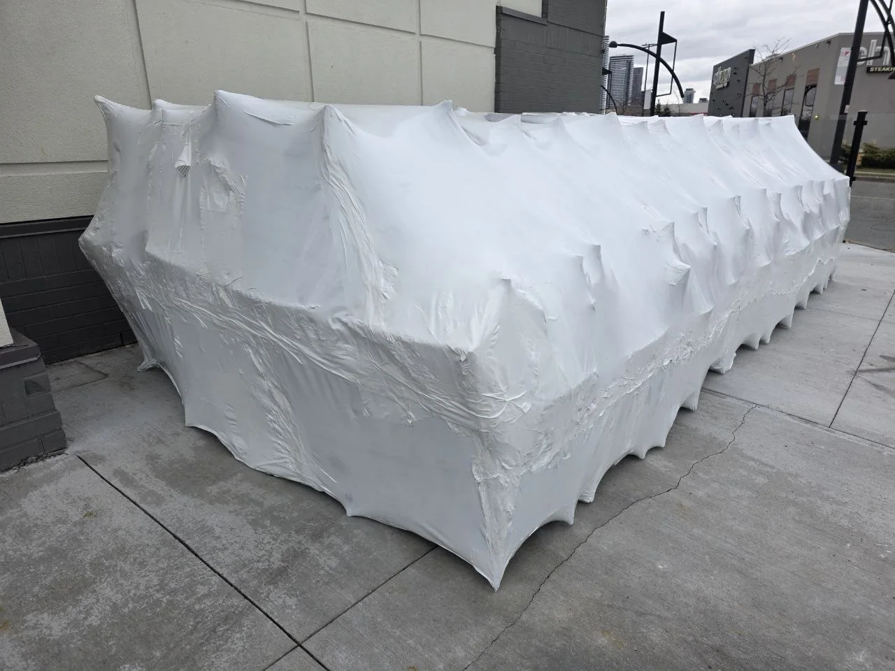 Large restaurant patio furniture collection sealed in white shrink wrap