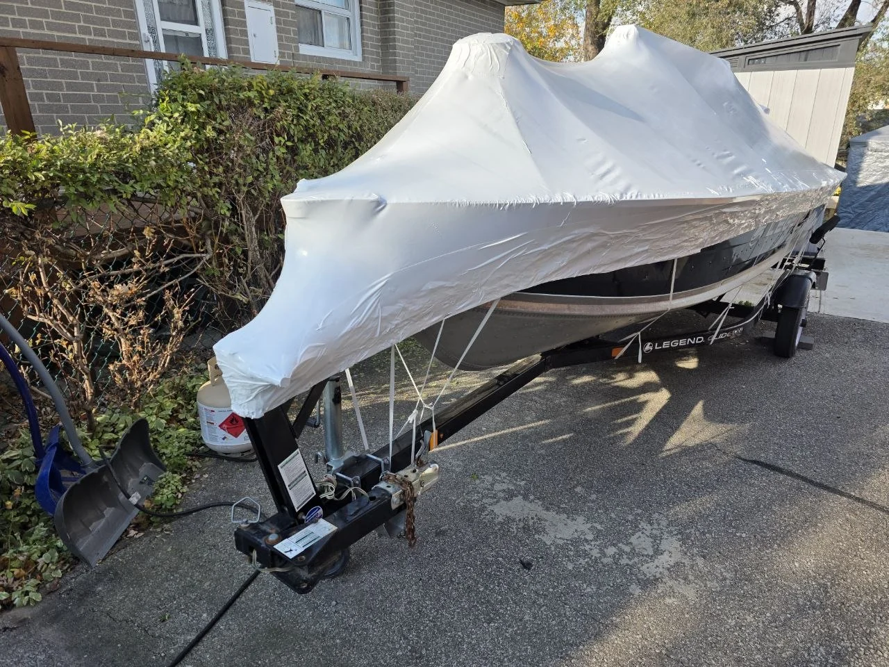 Boat on a trailer protected by shrink wrap
