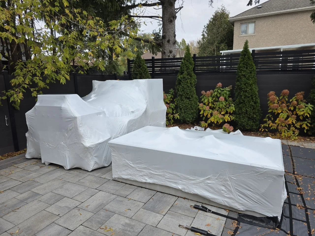 Residential patio furniture professionally shrink wrapped under a gazebo